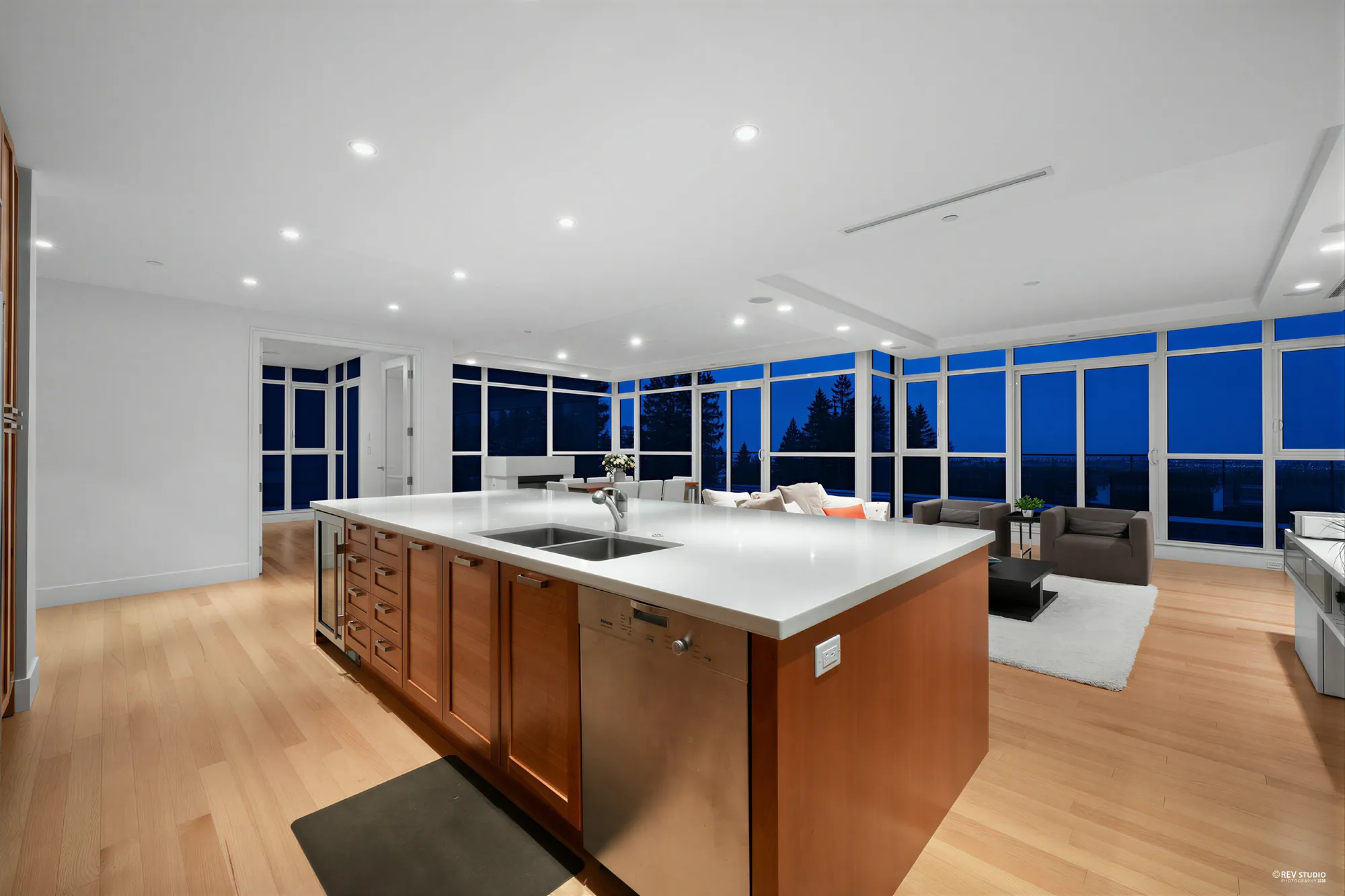 The island at dusk, the windows dark blue beyond the dining area